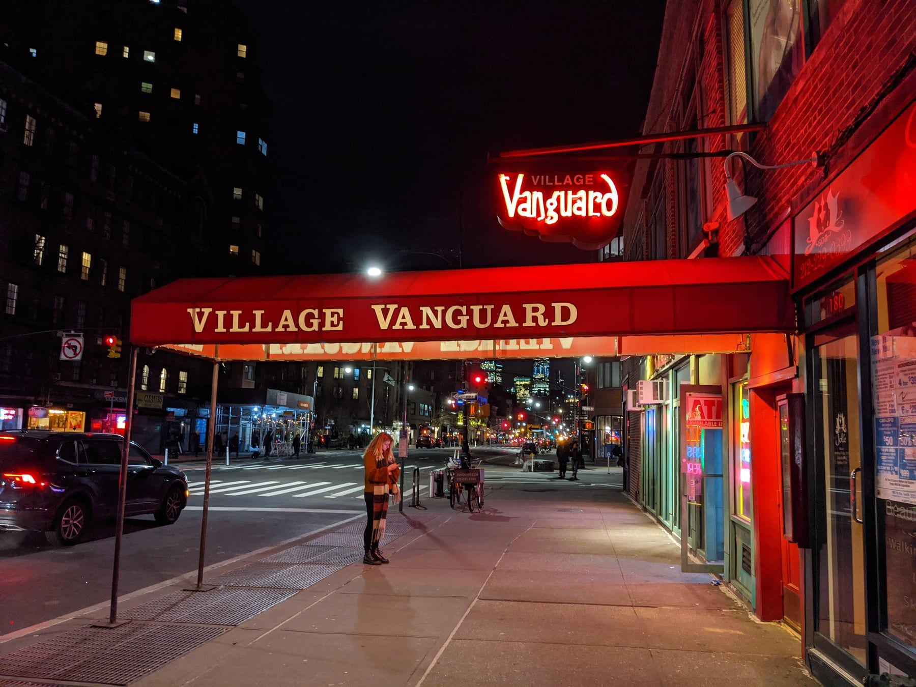Village Vanguard jazz club at night, red awning and neon sign on a New York street
